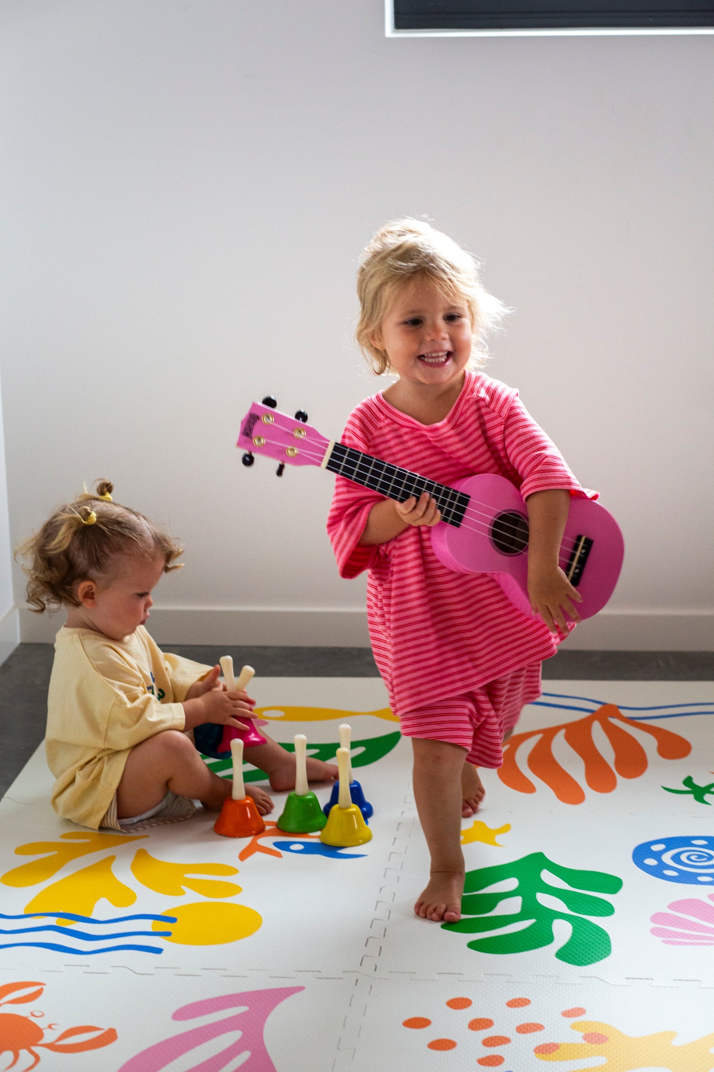 Children playing on colourful non toxic foam play mat